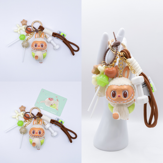 Golden Keychain with Labubu Lazy Yoga Figure and matching charms from three different angles on a white background