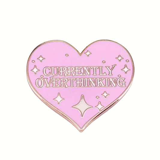 Heart-shaped pink enamel pin with 'Currently Overthinking' text on a white background
