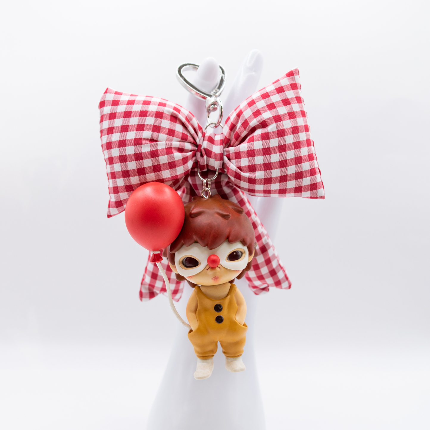 Silver keychain with red and white checkered bow and Hirono Persona figure from POP MART's Little Mischief series.