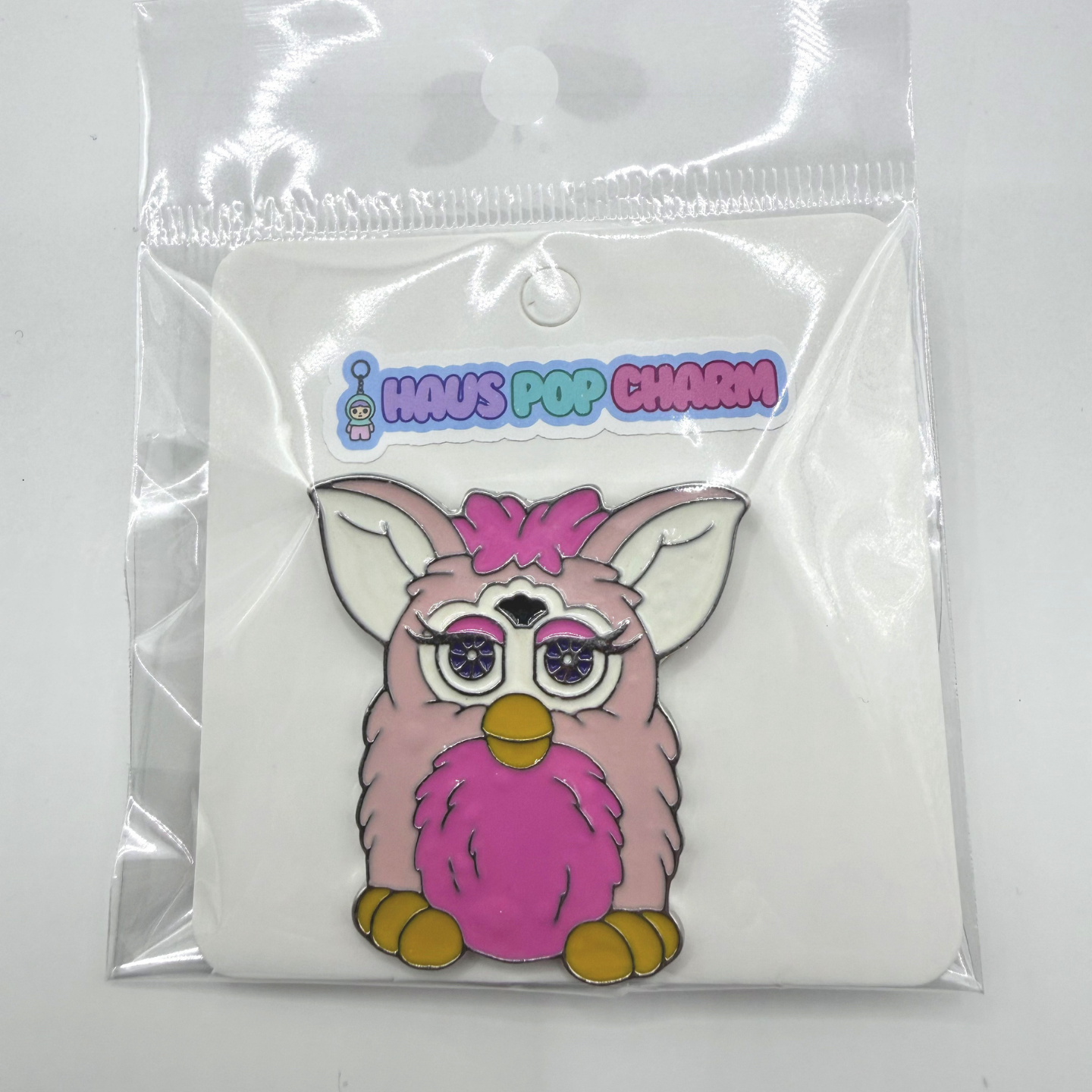 Pink owl charm in clear packaging with 'Haus Pop Charm' branding.