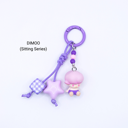 Purple keychain with Dimoo pop bean from the Sitting Series with matching star and dice charms
