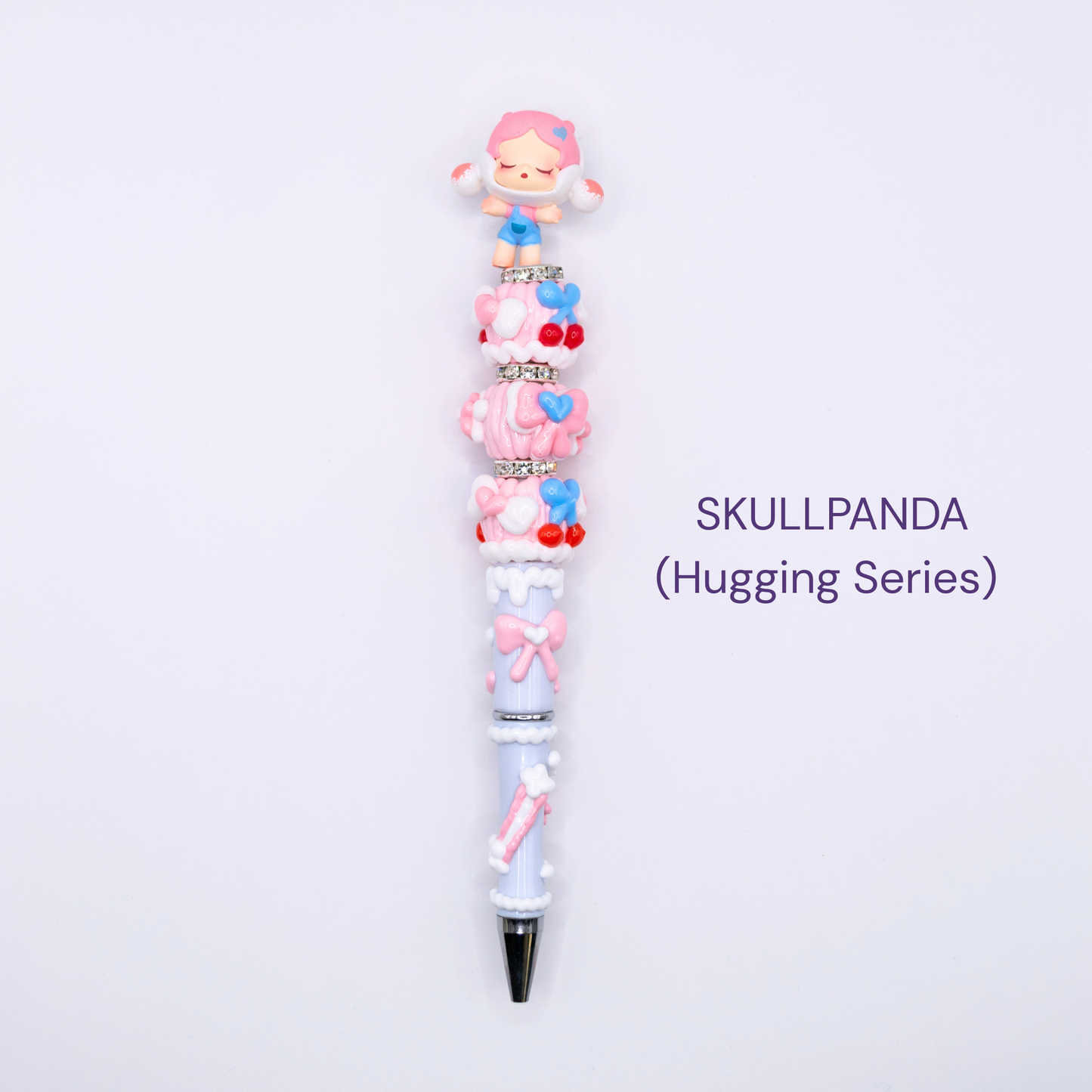 Colorful beaded pen with cartoon character design on a white background, labeled 'SKULLPANDA Hugging Series'.