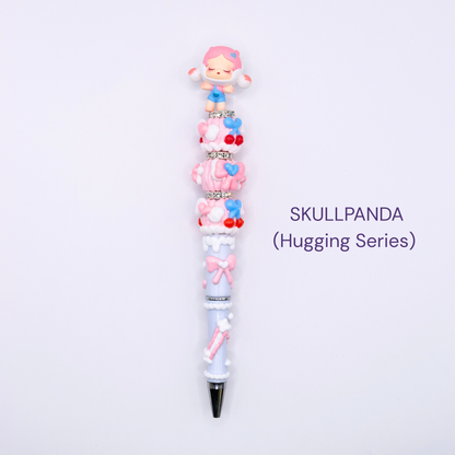 Colorful beaded pen with cartoon character design on a white background, labeled 'SKULLPANDA Hugging Series'.