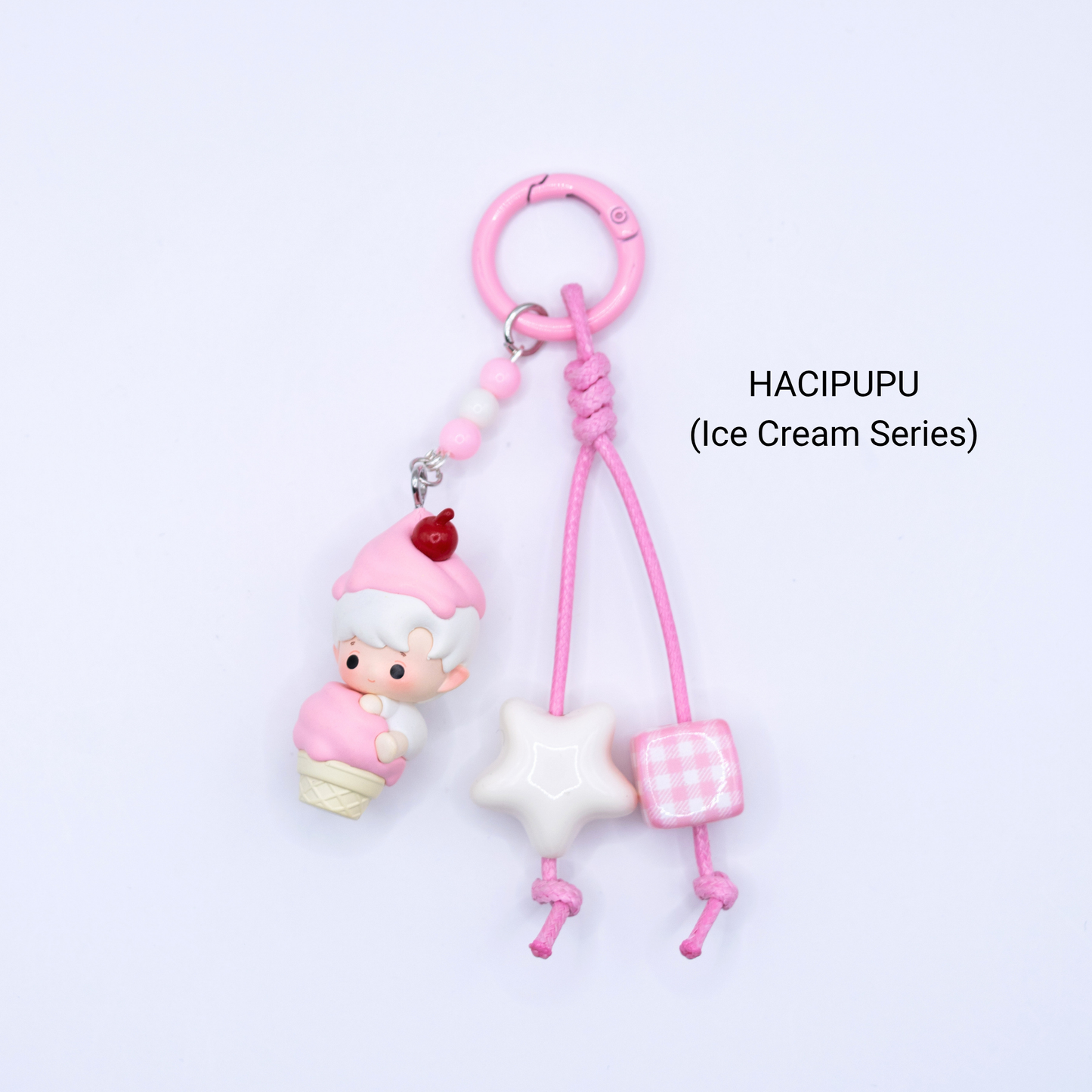 Pink keychain with Hacipupu pop bean from the Ice Cream Series with matching star and dice charms