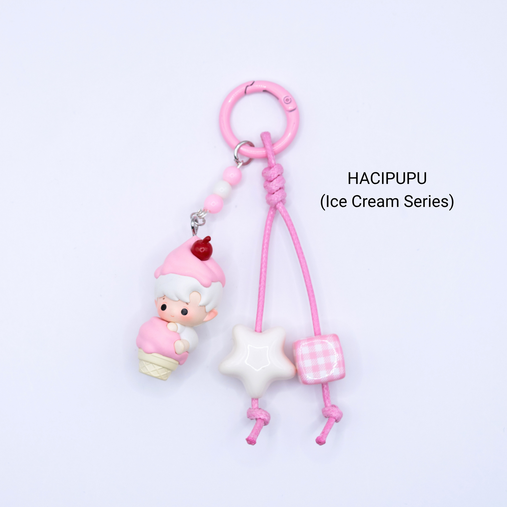 Pink keychain with Hacipupu pop bean from the Ice Cream Series with matching star and dice charms