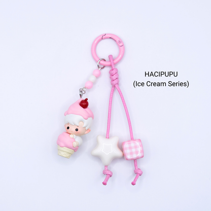 Pink keychain with Hacipupu pop bean from the Ice Cream Series with matching star and dice charms