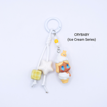 White keychain with Crybaby pop bean from the Ice Cream Series with matching star and dice charms