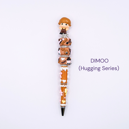 Beaded pen with cartoon character design on a white background, labeled 'DIMOO Hugging Series'.