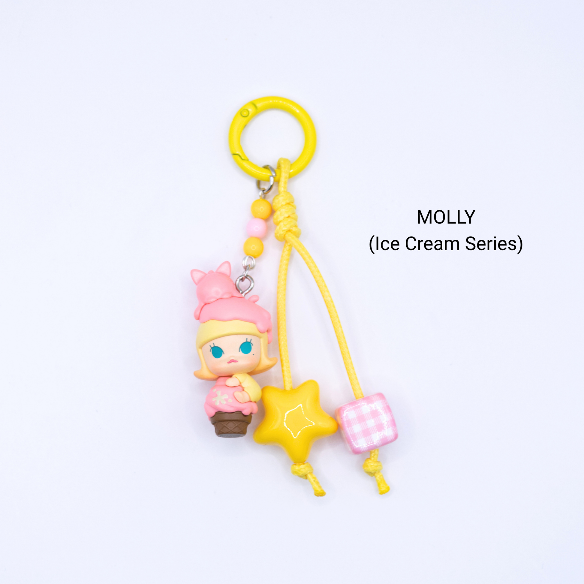 Yellow keychain with Molly pop bean from the Ice Cream Series with matching star and dice charms