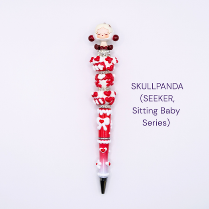 Colorful beaded pen with cartoon character design on a white background, labeled 'SKULLPANDA (SEEKER, Sitting Baby series)'.