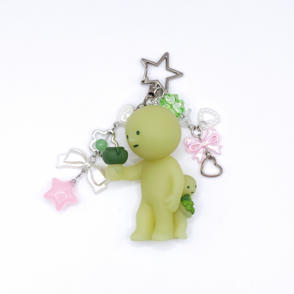 Keychain with Smiski Bacchus figure from the Museum series with star clasp and matching charms on a white background