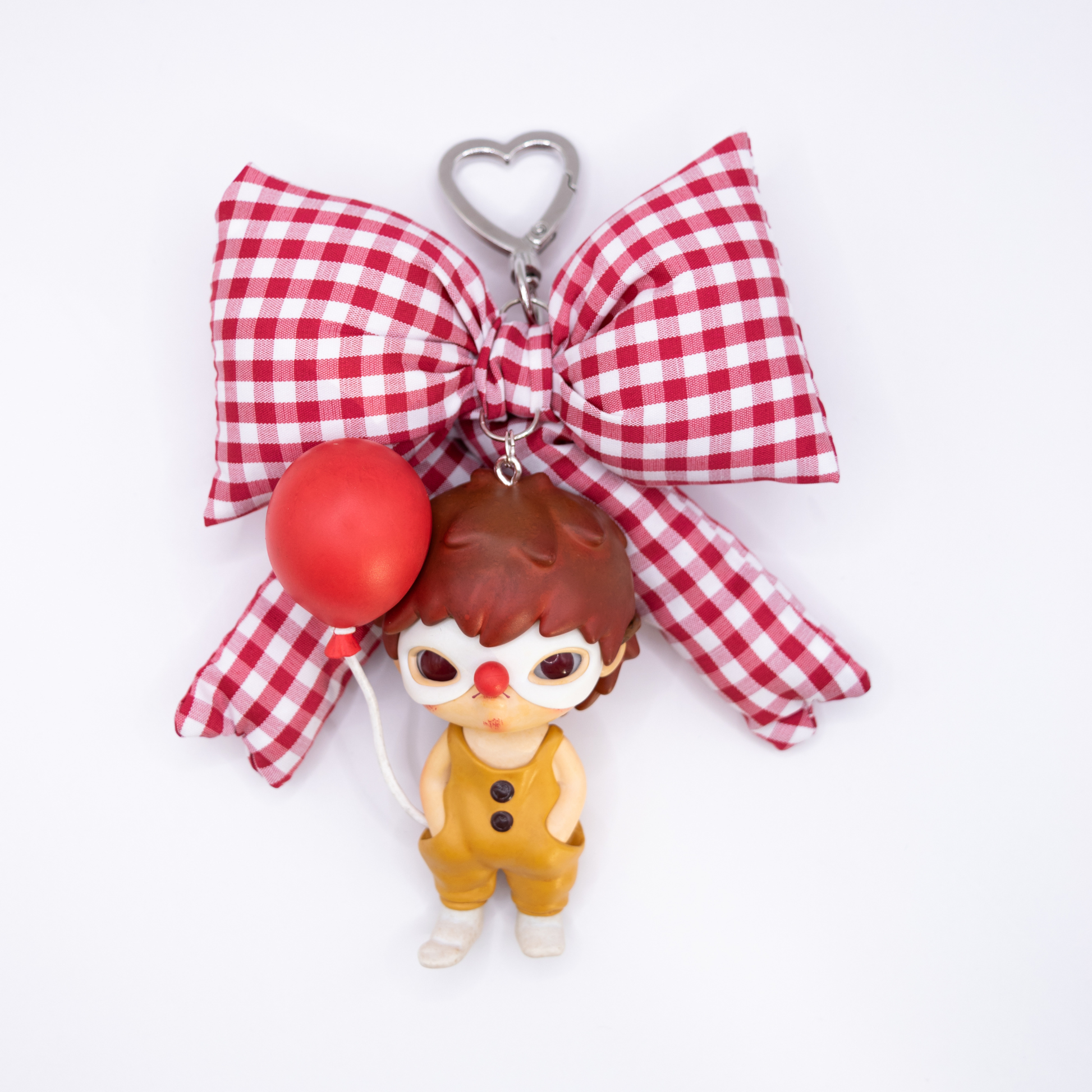 Silver keychain with red and white checkered bow and Hirono Persona figure from POP MART's Little Mischief series.