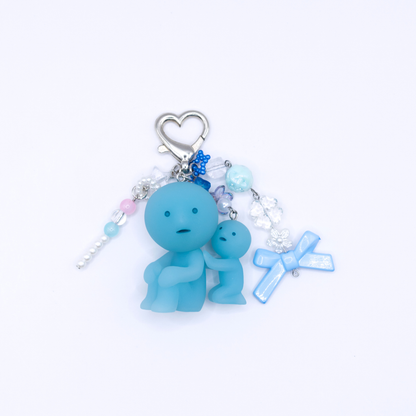 Keychain with Smiski Scrubbing figure from the bath series with heart clasp and matching charms on a white background