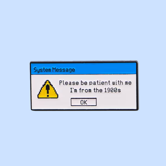 Pixelated system message dialog box on a light blue background with text 'Please be patient with me. I'm from the 1990s'.