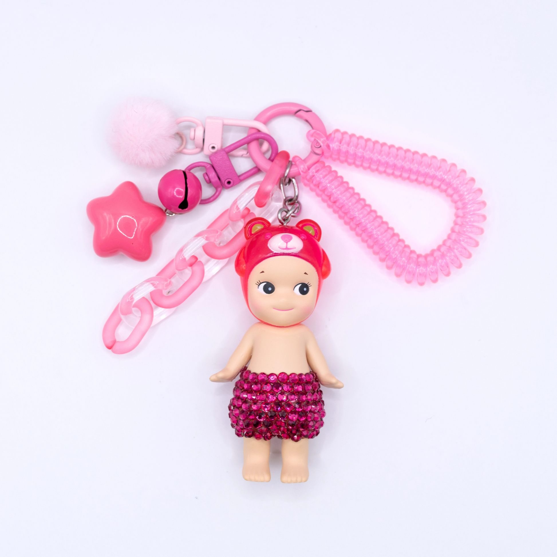Pink Peach Bear Sonny Angel fiigure with added rhinestones on a pink kreychain with matching charm