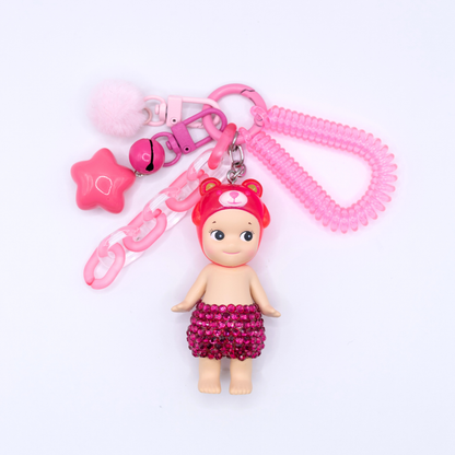 Pink Peach Bear Sonny Angel fiigure with added rhinestones on a pink kreychain with matching charm