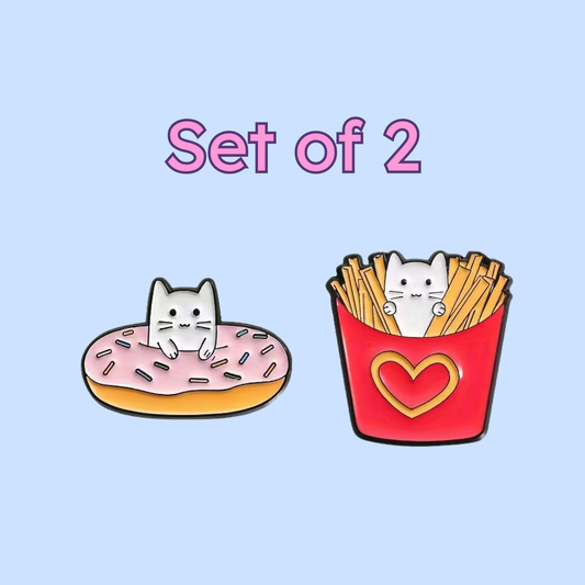 Two cartoon pins featuring a cat on a donut and a cat in a basket of fries with a heart on a light blue background.