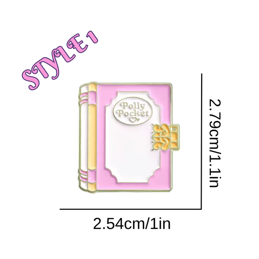 Pink book-shaped brooch with 'Polly Pocket' text, measurements indicated on a white background.