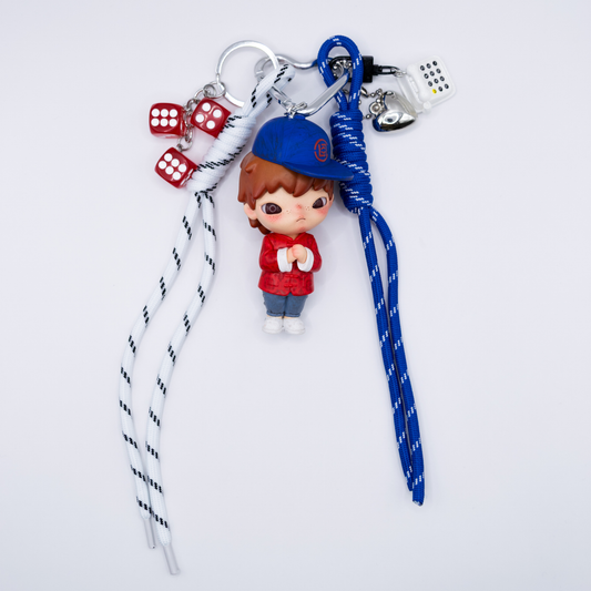 Silver heart keychain with Hirono Silk Royale figure from POP MART's Clot series and matching charms including blue lanyard, black and white lanyard, silver heart, white rotary phone, three red dice.