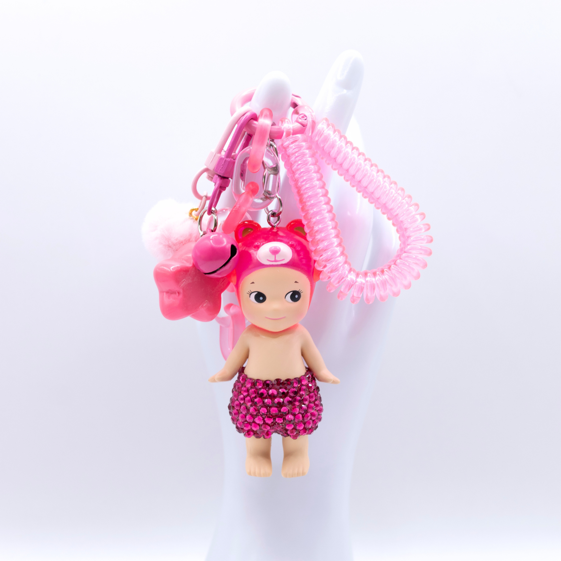 Pink Peach Bear Sonny Angel fiigure with added rhinestones on a pink kreychain with matching charm