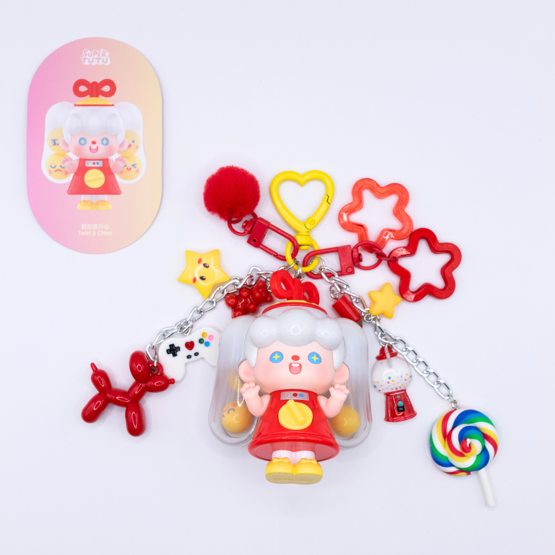 Heart keychain featuring Supertutu GAME START figure from Pop Mart's HAPPY-ING! Series and matching colorful charms on white background