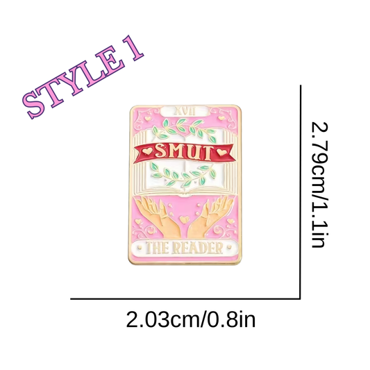 Pink enamel pin with 'Smut' and 'The Reader' text, dimensions shown on a white background.