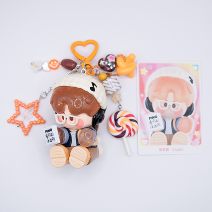 Orange heart keychain with Pino Jelly SStudio figure from Pop Mart's Star Project Series with matching charms including lollipop, star, notes, heart) next to its card