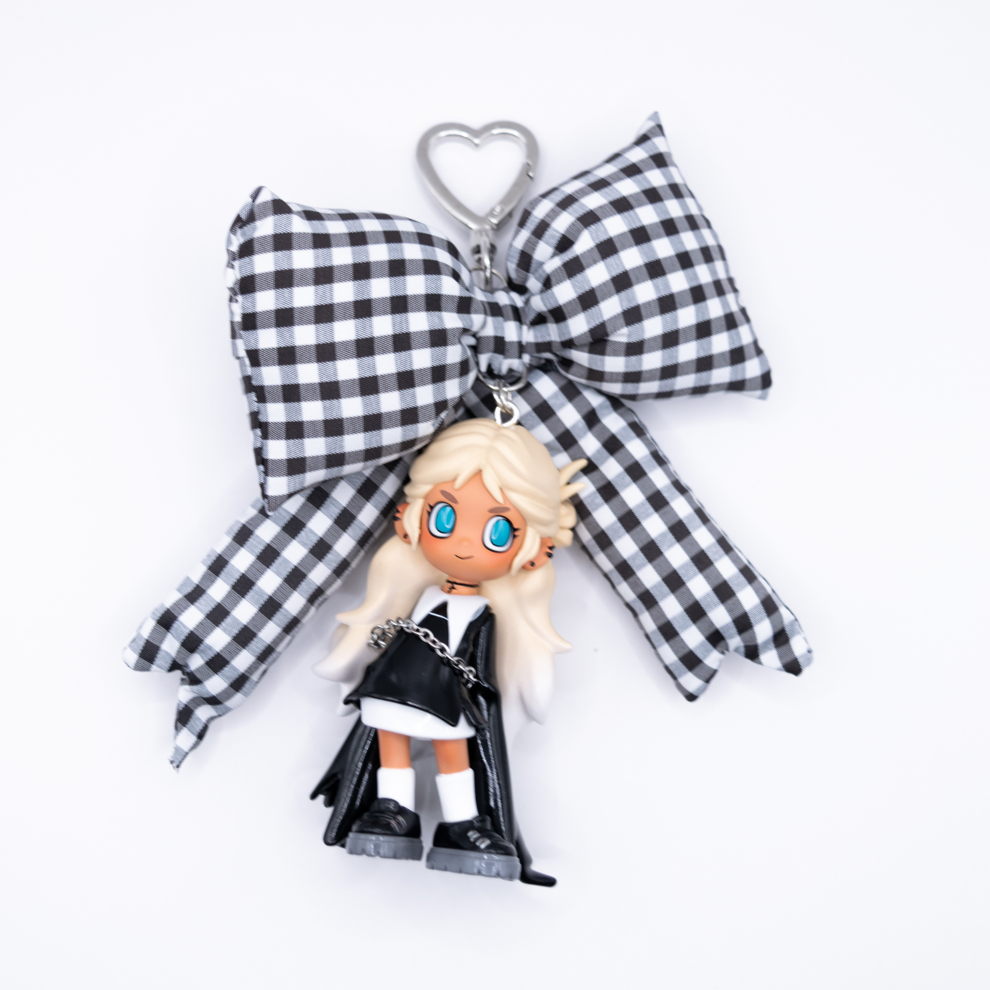 Silver keychain with Lil Peach Riot  Poppy Saint from POP MART's Loading series on a black and white gingham bow