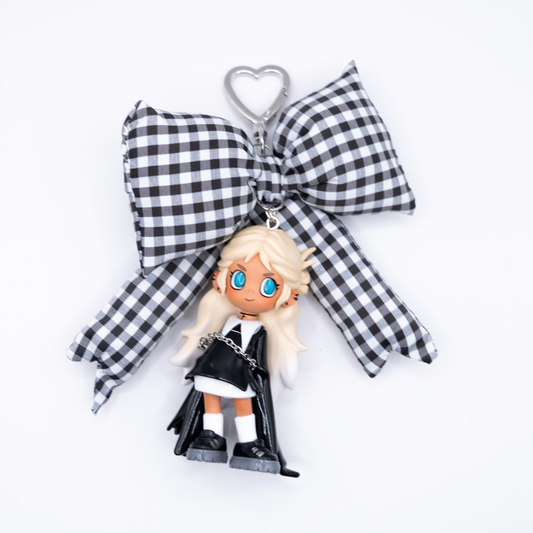 Silver keychain with Lil Peach Riot  Poppy Saint from POP MART's Loading series on a black and white gingham bow