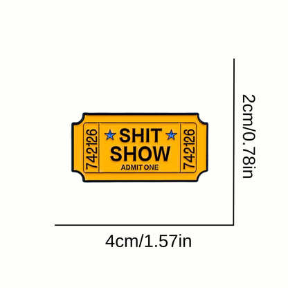 Yellow ticket-shaped pin with 'SHIT SHOW' text and dimensions on a white background