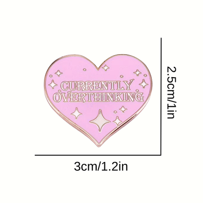 Heart-shaped pink enamel pin with 'Currently Overthinking' text and star designs, shown with dimensions on a white background.