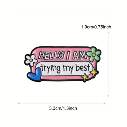 Pink badge with 'HELLO I AM trying my best' text and floral designs, with measurements on a white background.