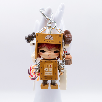 Silver heart keychain with Hirono Robot figure from POP MART's Little Mischief series and matching charms including a lollipop, stars, gummy bear, cupcake, and lego piece.