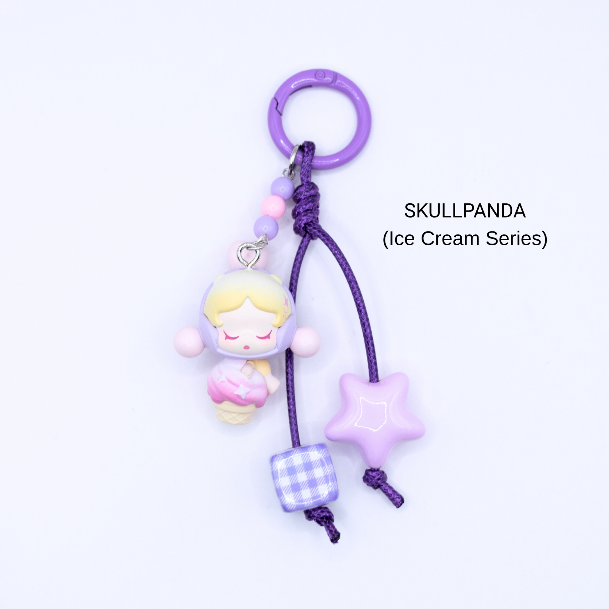 Purple keychain with Skullpanda pop bean from the Ice Cream Series with matching star and dice charms