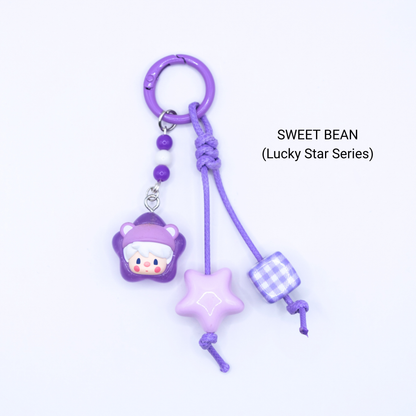 Purple keychain with Sweet Bean pop bean from the Lucky Star Series with matching star and dice charms
