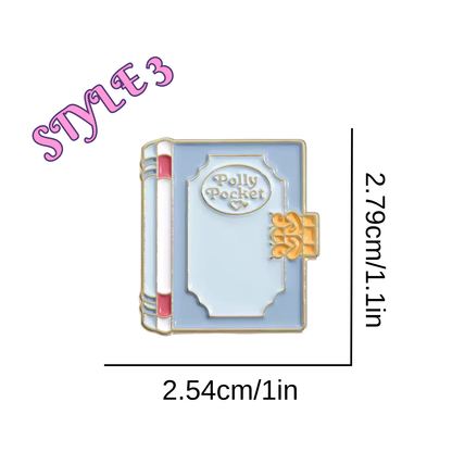 Book-shaped pin with 'Polly Pocket' text, measurements indicated on a white background
