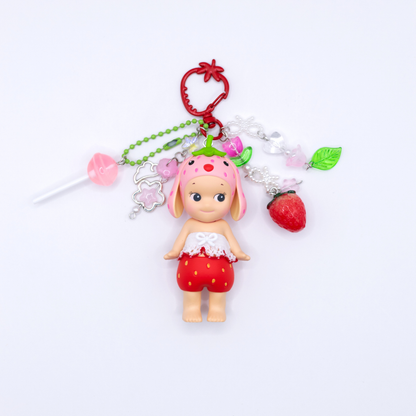 Sonny Angel keychains with Lop Ear Rabbit figure from the Strawberry Love series on a red strawberry clasp with matching beads