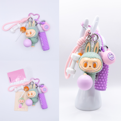 Pink Keychain with Labubu Lazy Yoga Zone Out Figure and matching charms from three different angles on a white background
