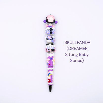 Colorful beaded pen with cartoon character design on a white background, labeled 'SKULLPANDA DREAMER Sitting Baby Series'.