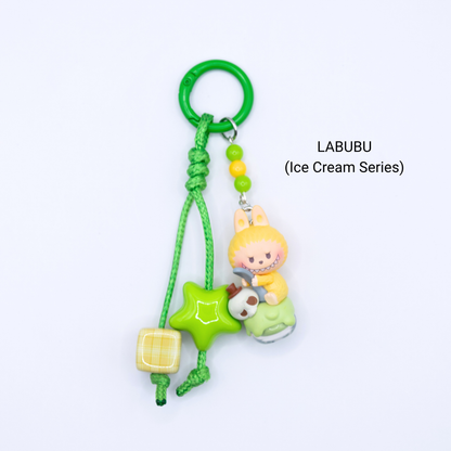 Green keychain with Labubu pop bean from the Ice Cream Series with matching star and dice charms