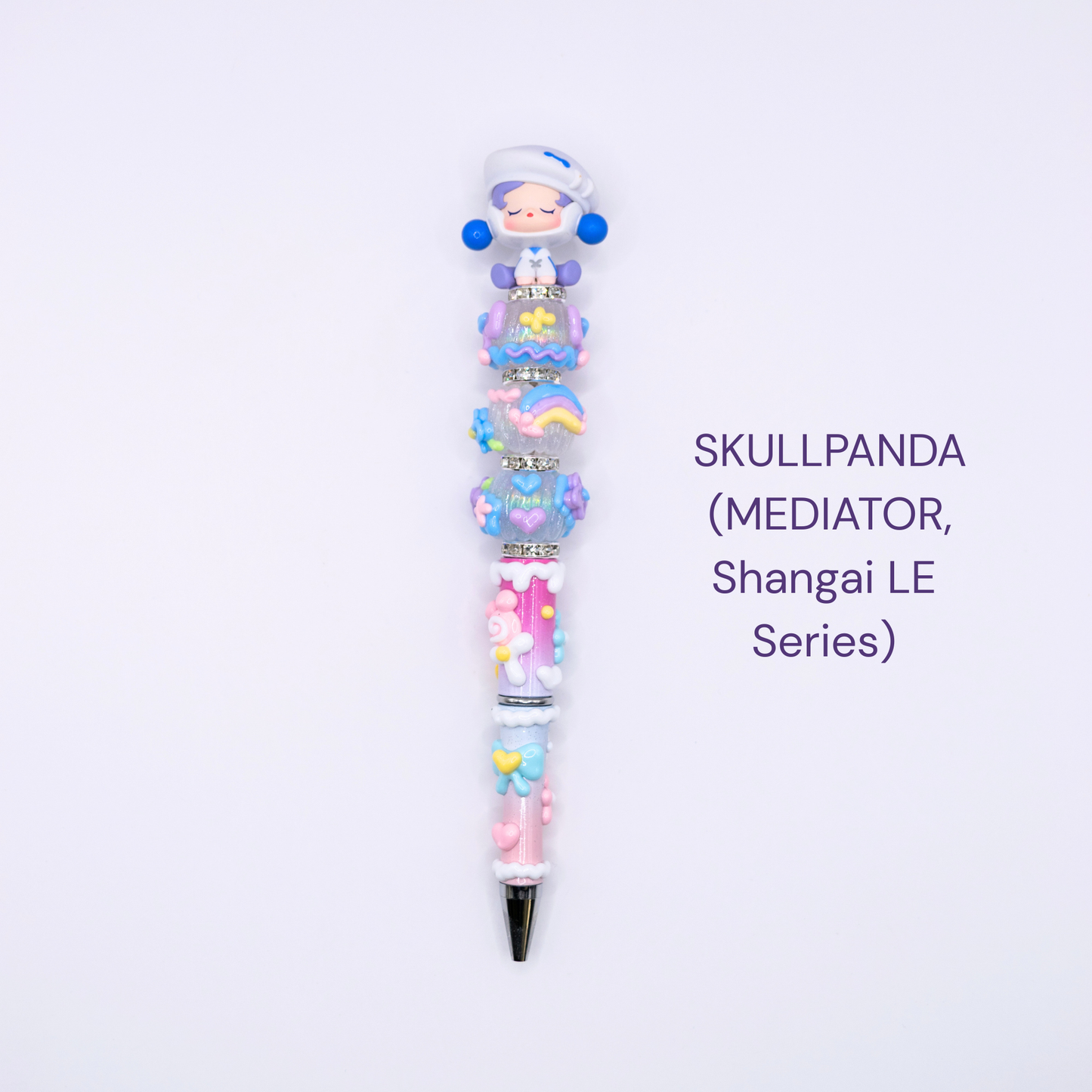 Colorful beaded pen with cartoon character design on a white background, labeled 'SKULLPANDA Mediator Shangai LE Series'.