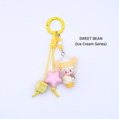 Yellow keychain with Sweet Bean pop bean from the Ice Cream Series with matching star and dice charms