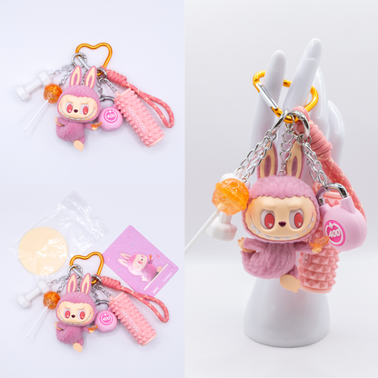 Orange Keychain with Labubu Lazy Yoga Confident Figure and matching charms from three different angles on a white background