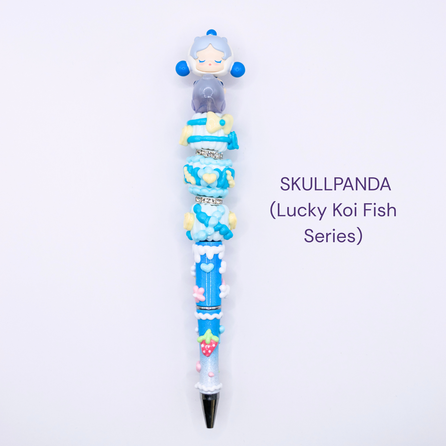 Colorful beaded pen with cartoon character design on a white background, labeled 'SKULLPANDA Lucky Koi Fish Series'.