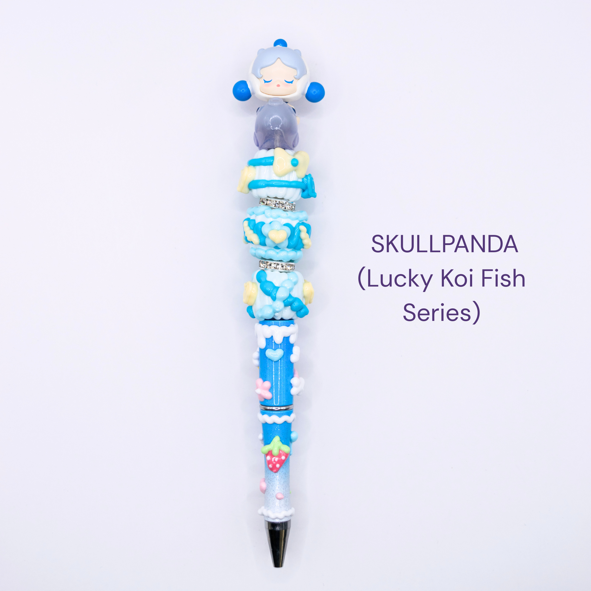 Colorful beaded pen with cartoon character design on a white background, labeled 'SKULLPANDA Lucky Koi Fish Series'.